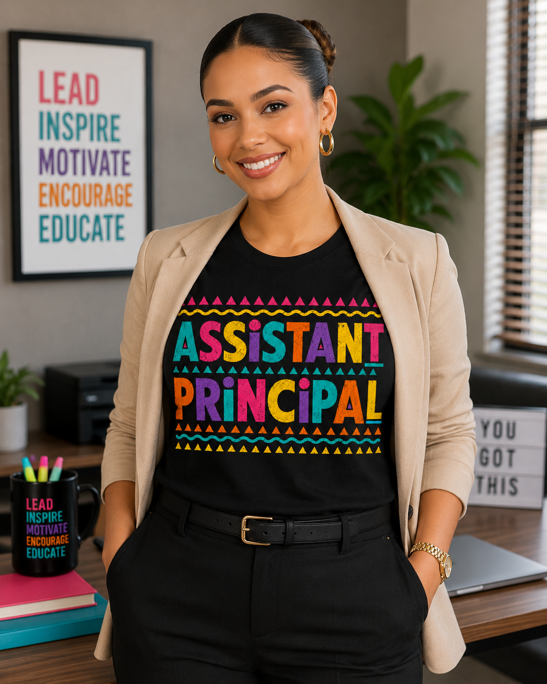 Business casual mockup of a woman wearing a colorful retro Assistant Principal graphic T-shirt with a beige blazer in an office setting.